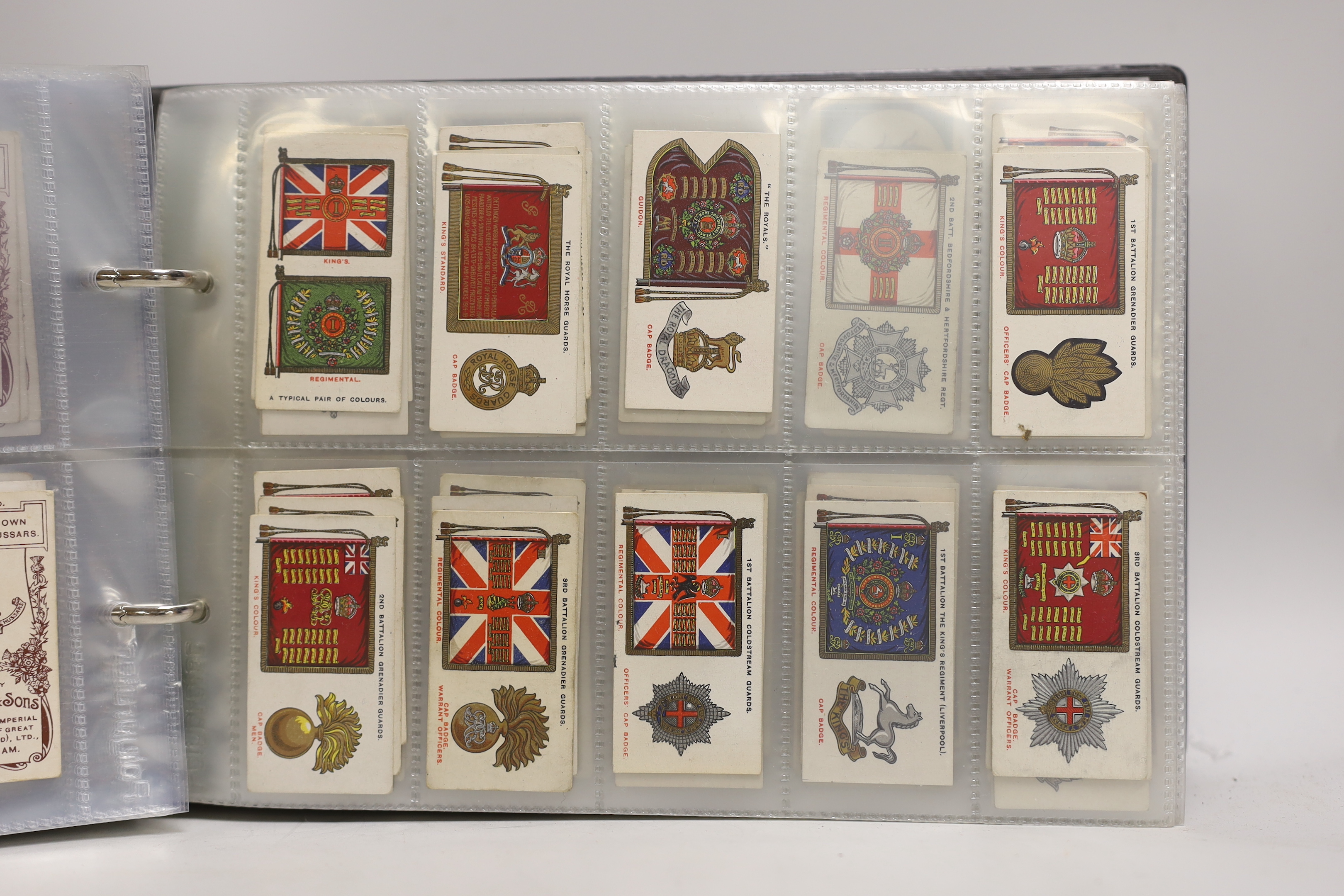 A collection of cigarette cards, some arranged in albums including Wills